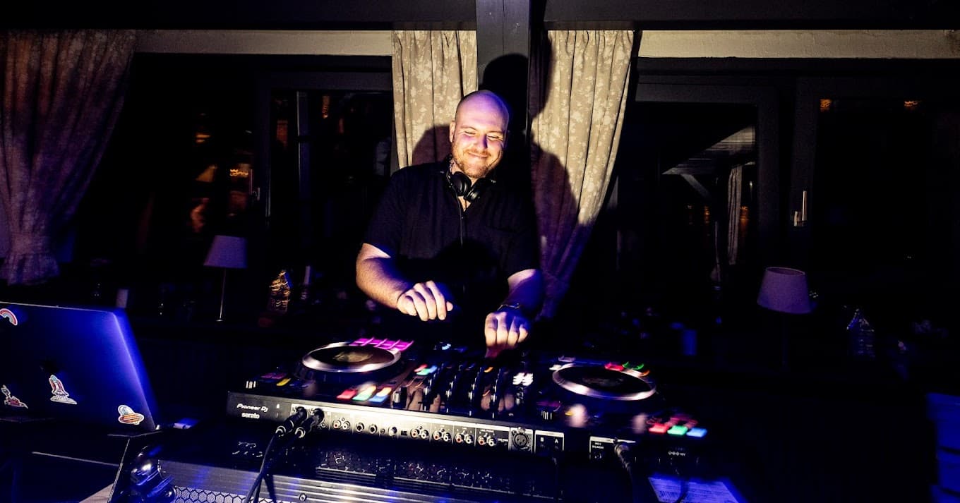DJ Daniel Daub hinter dem DJ-Pult bei einer Hochzeitsfeier